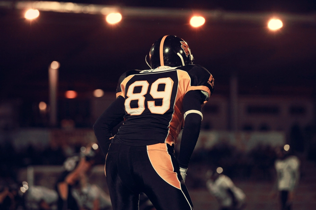 Football player on the field under stadium lights