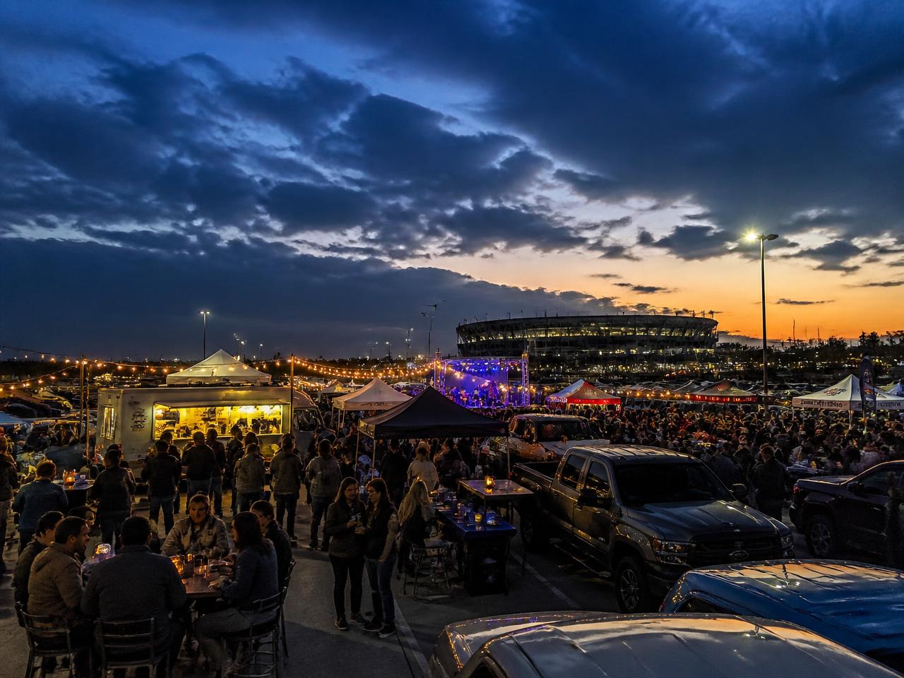 Tailgate festival with food trucks at dusk
